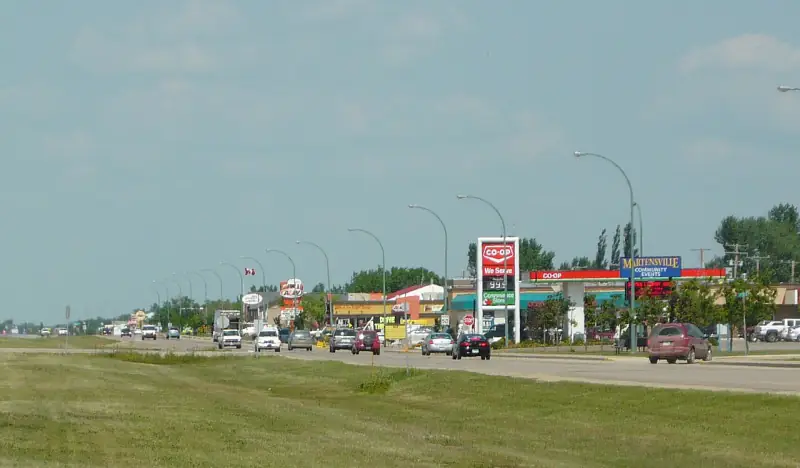 Highway commercial strip in Martensville with the Co-op gas bar and the Martensville community events sign