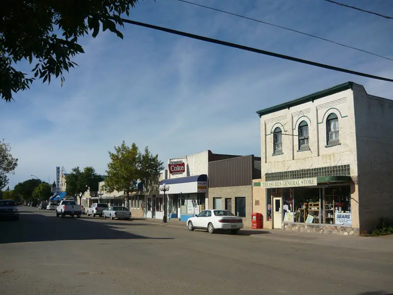 Rosthern's main street with the two-storey Treasures General Store building and shops under a prairie sky