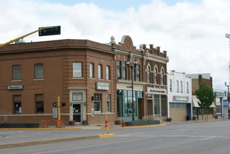 Historic brick storefronts on Yorkton's main commercial street, with the Alexander's building on the corner