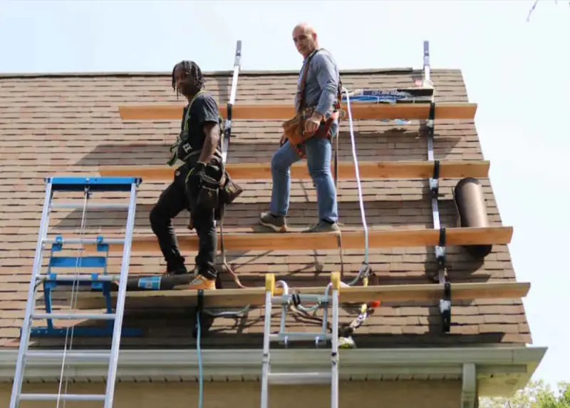 W Contracting crew working on a roof
