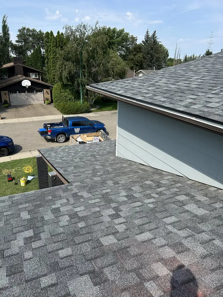 The W Contracting truck on site while the house and garage roofs go on, Saskatoon, SK