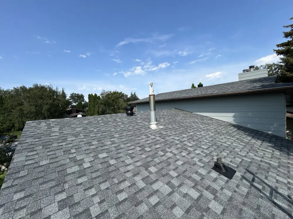A finished shingle roof with new pipe boots and vent flashing, Saskatoon, SK