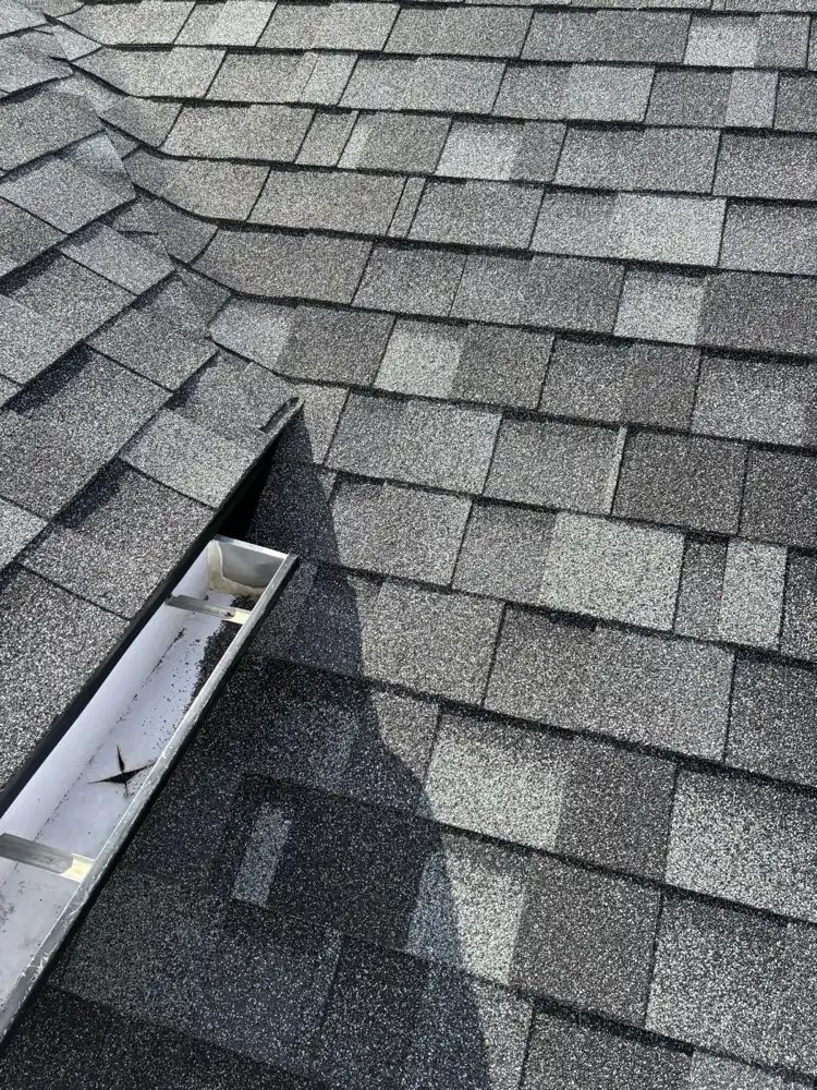 Asphalt shingle roof valley running down to the eavestrough on a Hampton Village home, Saskatoon, SK