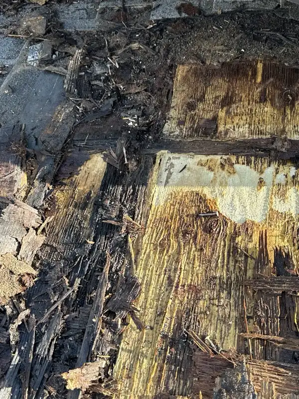 Close-up of rotted, water-stained roof sheathing found during the demo, on the Roof Replacement in Saskatoon page