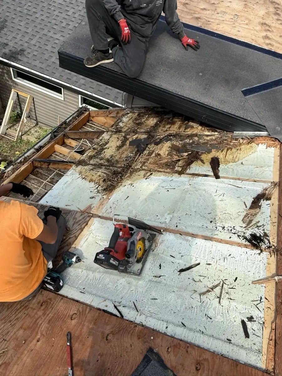 Crew tearing off a roof and finding rotted sheathing and wood along the eave